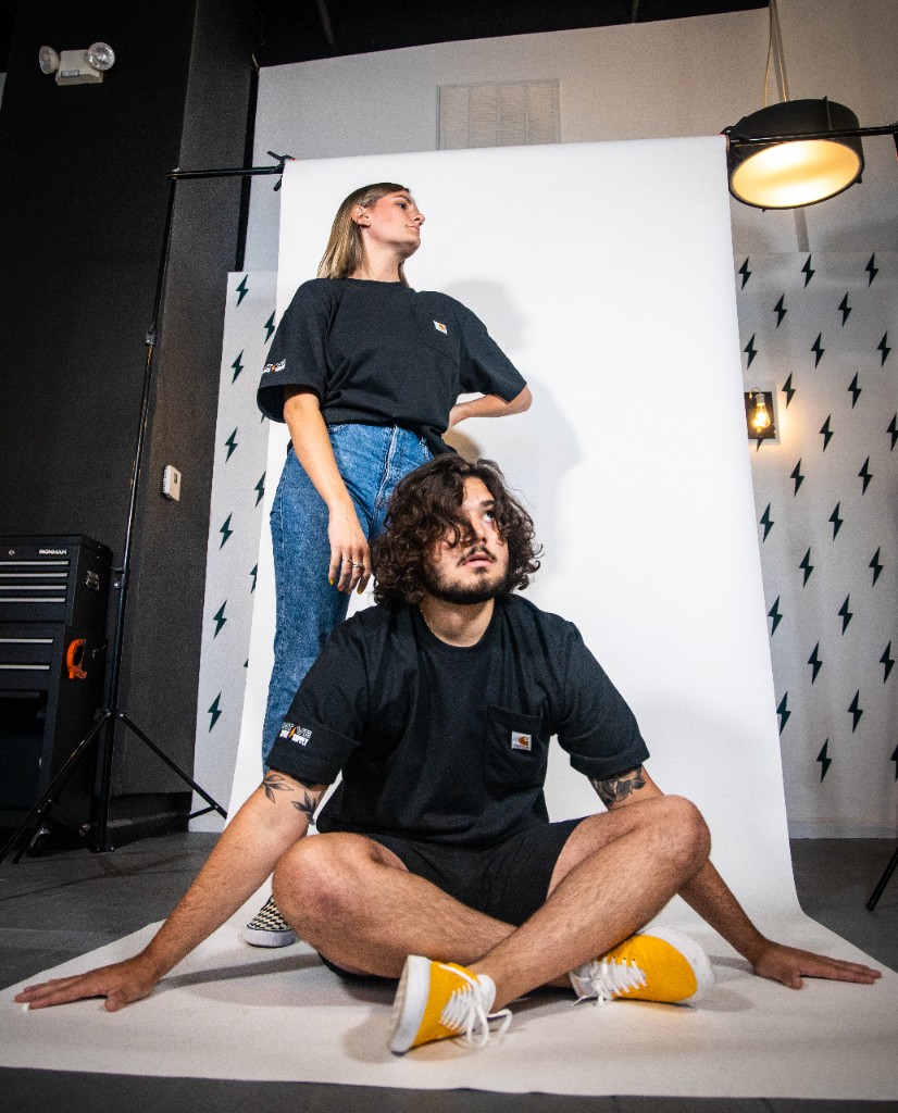 Studio photograph with models on white seamless and lightning bolt pattern wall