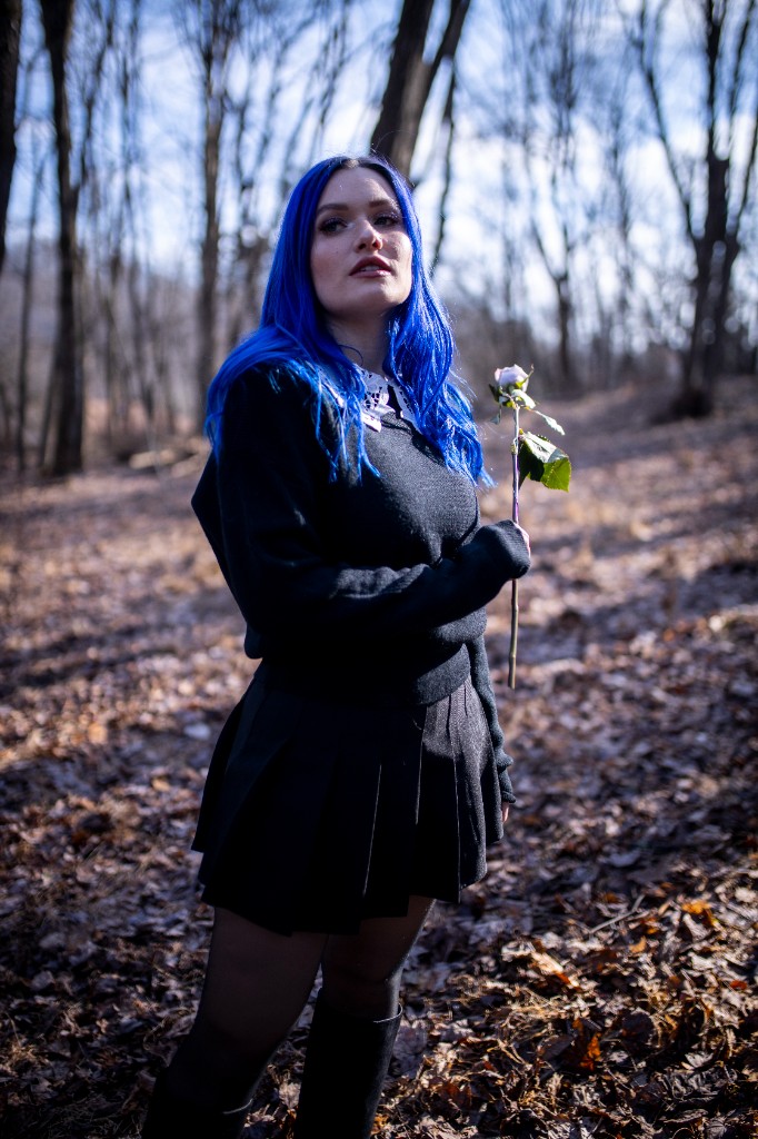 Portrait partially obscured by tree branch in foreground