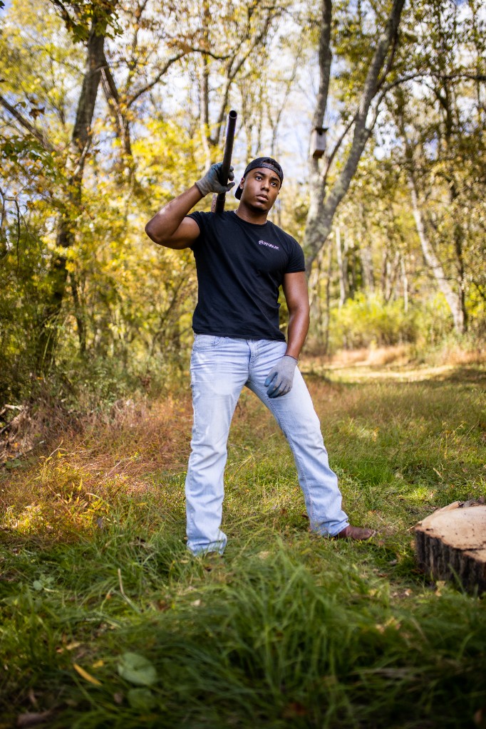 Tony Evans Jr. in wooded clearing with shotgun over shoulder